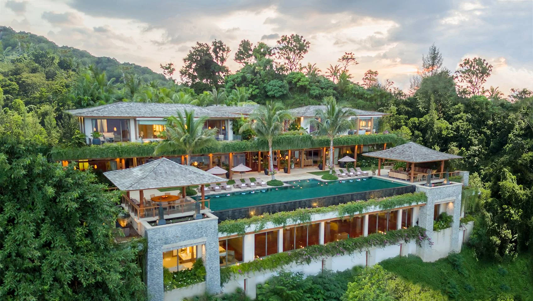 Aerial view of the Villa Sawan estate at dusk, terraced above Kamala