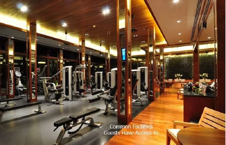 A gym with weight machines and free weights along a wood floored room; a caption in the corner reads Common Facilities Guests Have Access To