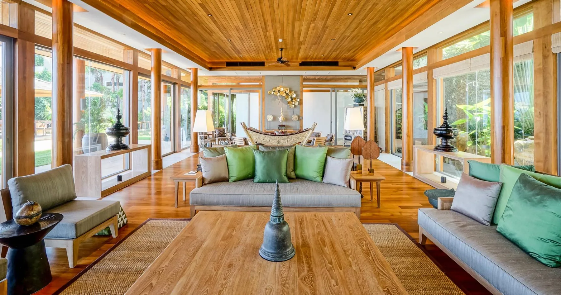 A living room with sofas and a coffee table under a wood ceiling
