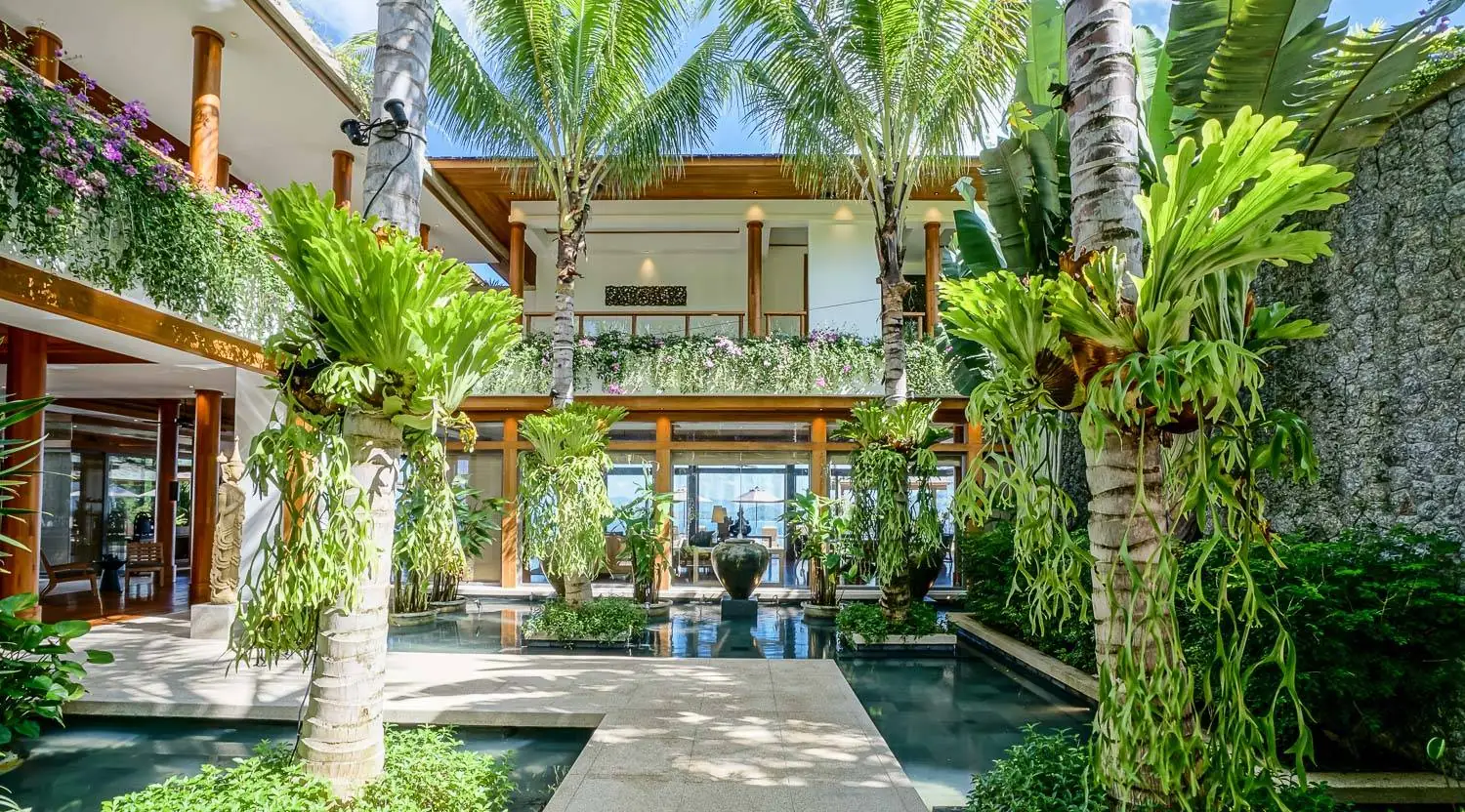 Tropical courtyard gardens and reflecting pools at the villa entrance